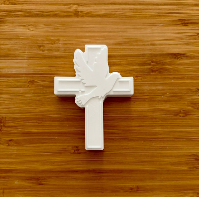 Unpainted cross with dove plaster piece on wood background