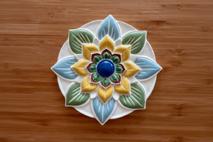 Mandala plate bisque on wood background