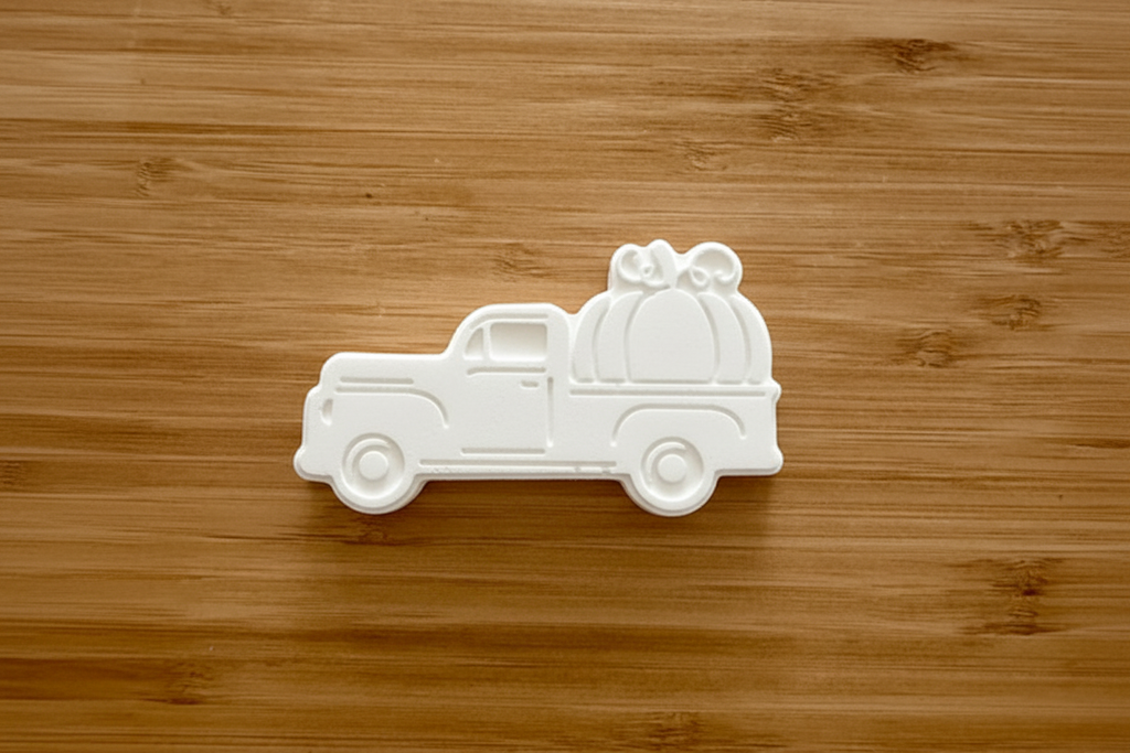 Vintage pumpkin truck bisque on wood background