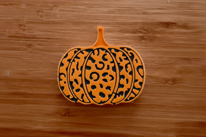 Painted orange leopard pumpkin on wood